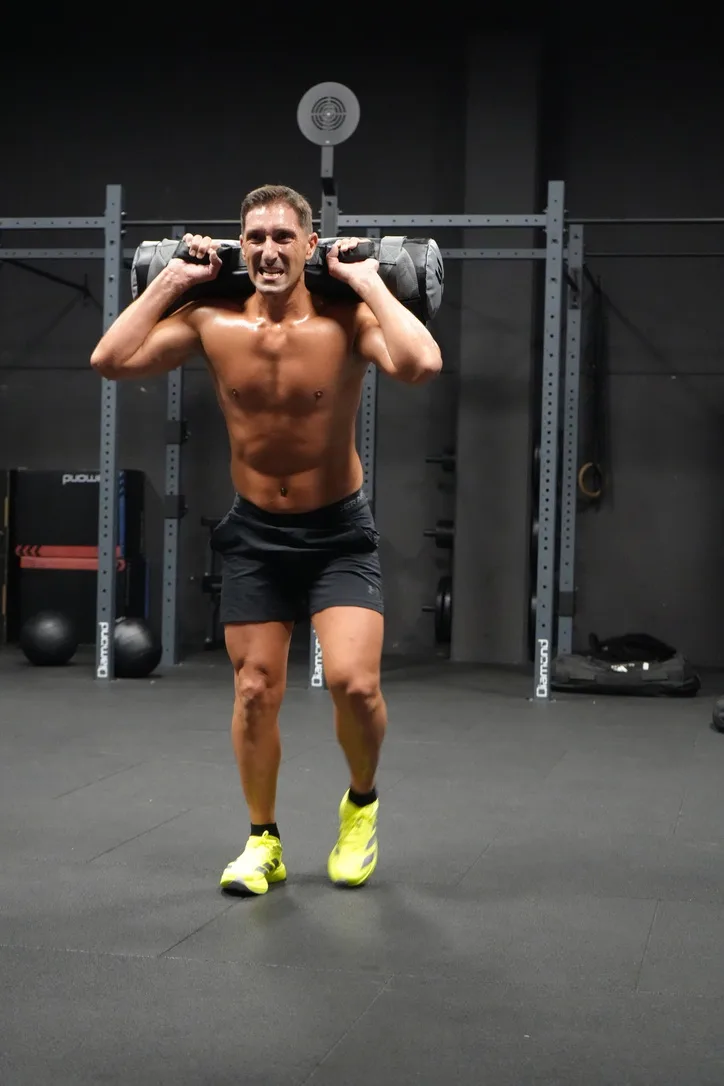 Uomo con sandbag sulle spalle